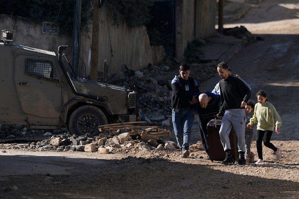 Palestinians flee an Israeli military raid on Jenin refugee camp in the West Bank on Wednesday, Nov. 29, 2023. (AP)