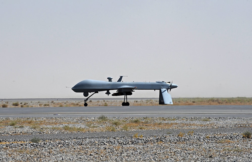 In this June 13, 2010, file photo a U.S. Predator unmanned drone armed with a missile stands on the tarmac of Kandahar military airport in Afghanistan (AP Photo/Massoud Hossaini, Pool, File)