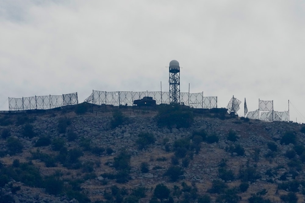 The fence of an Israeli military position is seen damaged after Hezbollah targeted it by rockets, on an occupied hill of Kfar Chouba village, southeast Lebanon, Sunday, Oct. 8, 2023. (AP)