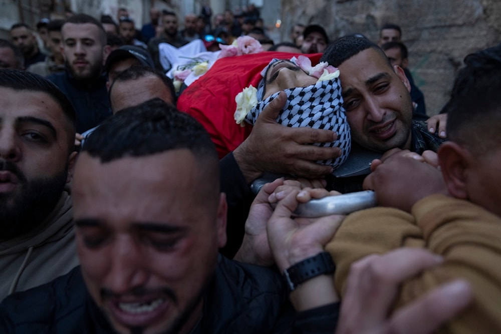 Palestinian mourners carry the body of Ali Alqam, 32, during his funeral in the West Bank refugee camp of Qalandia, south of Ramallah, Monday, Dec. 4, 2023. (AP)