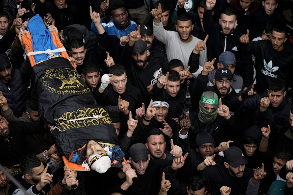Mourners carry the body of martyr Moath Zahran during his funeral at al-Fara Camp, West Bank, December 6, 2023 (AP)