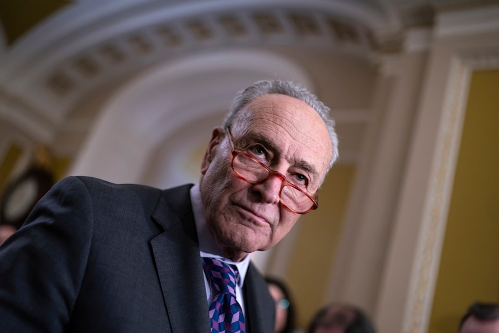 Senate Majority Leader Chuck Schumer, D-N.Y., answers questions from reporters outside the Senate chamber, at the Capitol in Washington, Tuesday, Nov. 28, 2023 (AP)