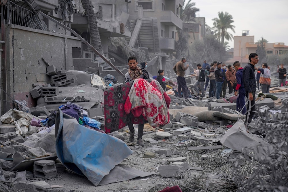 Palestinians look at destruction by the Israeli bombardment of the Gaza Strip, in Deir al Balah, Wednesday, Nov. 22, 2023. (AP)
