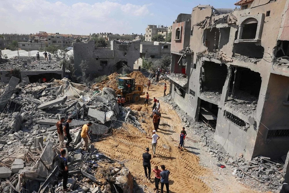 Palestinians search for their family members and neighbors under rubble after Israeli strikes on Rafah in southern Gaza on October 13, 2023. (AFP)