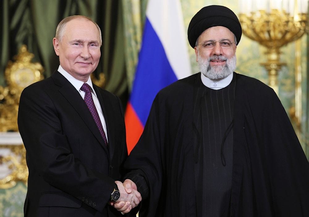 Russian President Vladimir Putin, left, and Iranian President Ebrahim Raisi shake hands during their meeting at the Kremlin in Moscow, Russia, Thursday, Dec. 7, 2023. (AP)