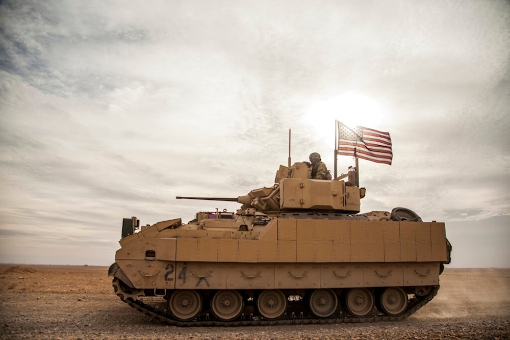 American soldiers drive a Bradley fighting vehicle during a joint exercise with Syrian Democratic Forces at the countryside of Deir Ezzor in northeastern Syria, Dec. 8, 2021 (AP)