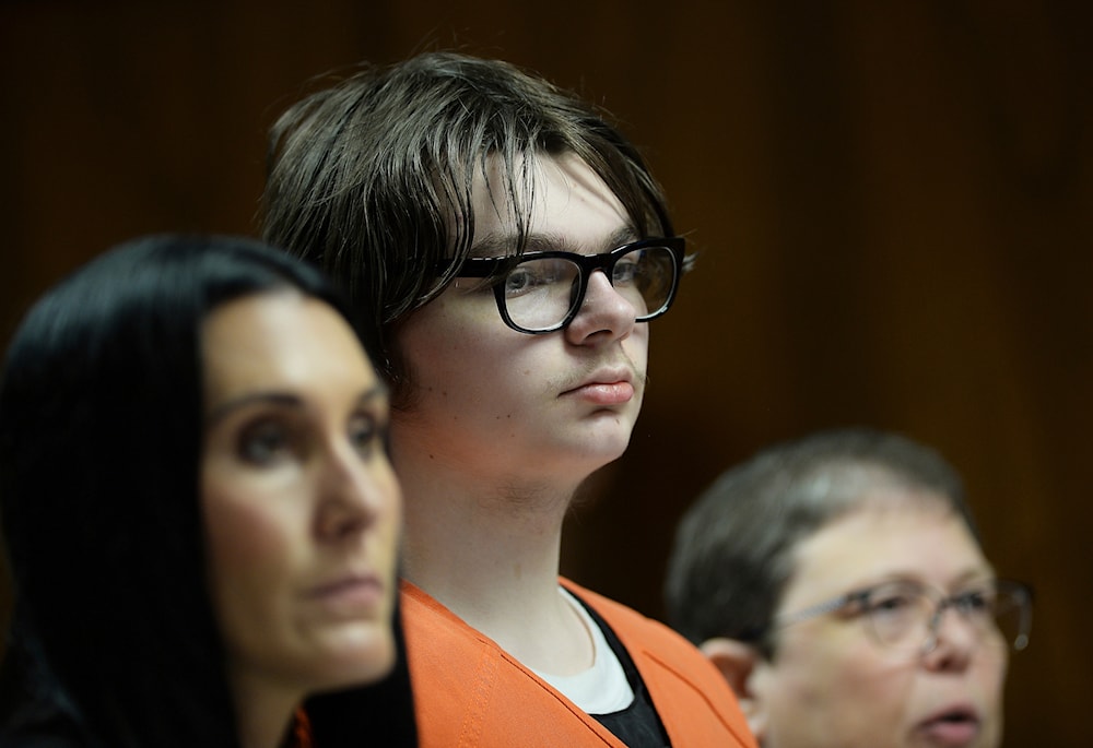 Ethan Crumbley stands with his attorneys, Paulette Loftin and Amy Hopp, during his hearing at Oakland County Circuit Court, Aug. 1, 2023, in Pontiac, Mich. (AP)