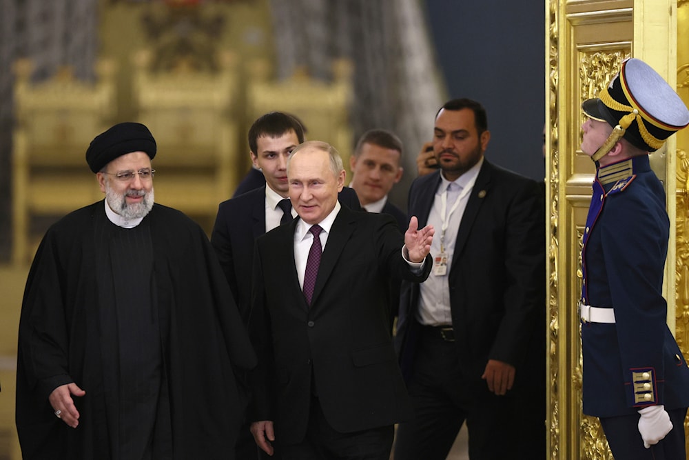 Russian President Vladimir Putin, center, welcomes Iranian President Ebrahim Raisi, left, for the talks at the Kremlin in Moscow, Russia, Thursday, Dec. 7, 2023. (AP)