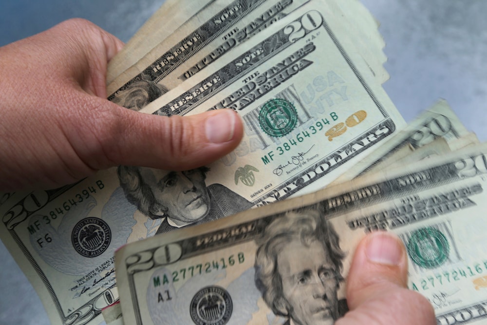  In this June 15, 2018 photo, twenty dollar bills are counted in North Andover, Mass (AP Photo/Elise Amendola, File)