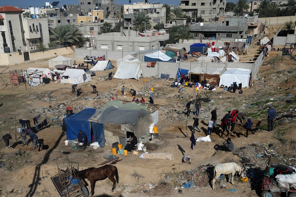 Palestinians displaced by the Israeli bombardment of the Gaza Strip set up tents in Deir al Balah, Tuesday, Dec. 26, 2023. (AP)