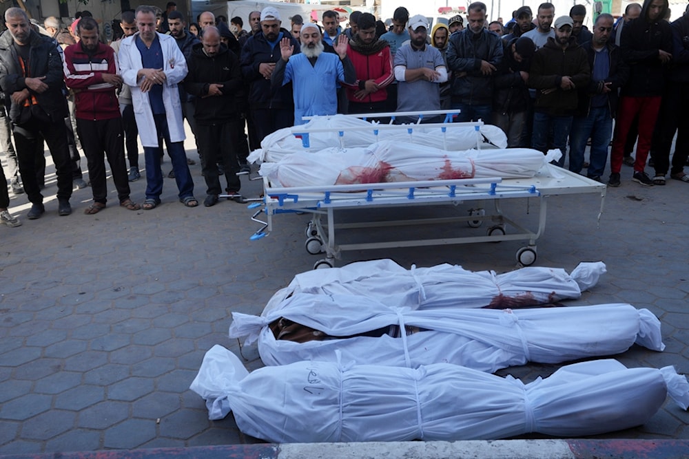 Palestinians mourn their relatives killed in the Israeli bombing of the Gaza Strip in Deir al Balah, Gaza Strip, on Monday, Jan. 8, 2024. (AP)