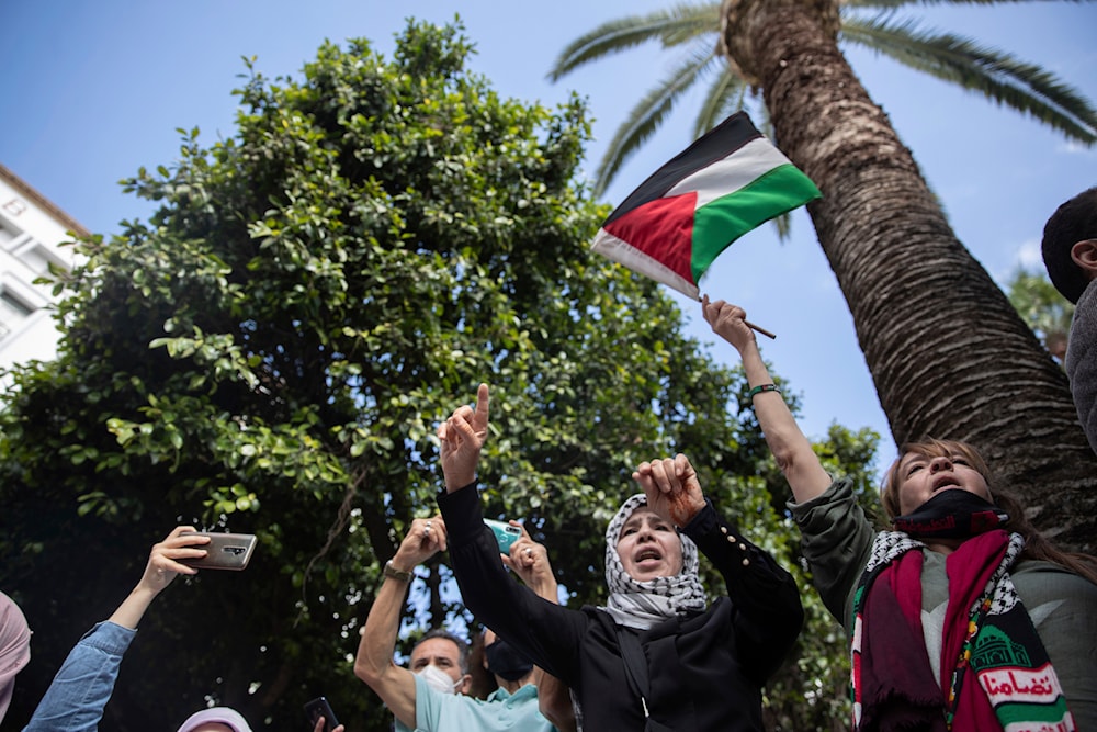 Protesters shout slogans and wave a flag during a protest in solidarity with the people of Palestine in Rabat, Morocco, May 10, 2021 (AP)