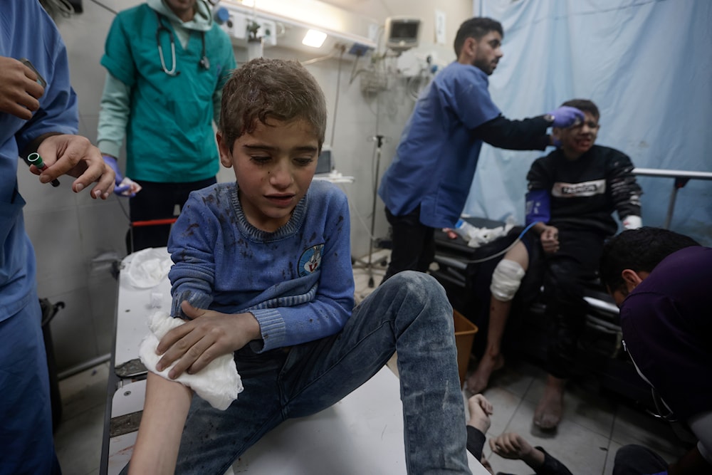 Palestinians wounded in Israeli bombardment, receive treatment at a hospital in Khan Younis refugee camp, southern Gaza Strip, occupied Palestine, January 11, 2024 (AP)