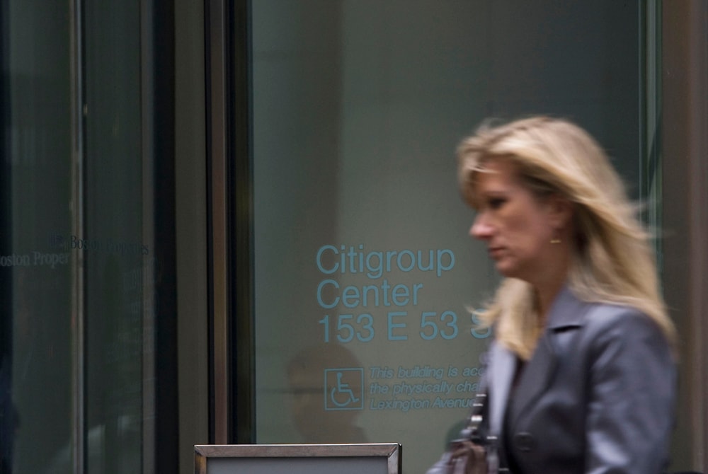 A woman walks out of the Citigroup center on Lexington Ave. on Friday, Nov. 14, 2008 in New York. (AP)