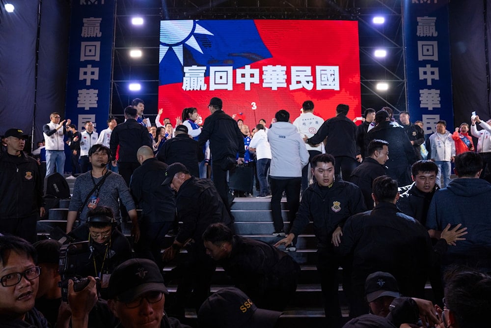 Security staff react after Kuomintang (KMT) presidential candidate Hou Yu-ih arrived at an election rally in New Taipei City, Taiwan on Friday, Jan. 12, 2024. (AP)