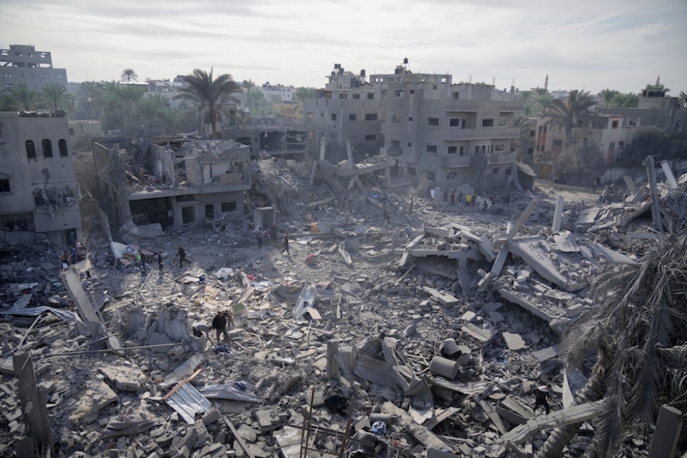 Palestinians look at destruction by the Israeli bombardment of the Gaza Strip, in Deir al Balah, occupied Palestine, Wednesday, Nov. 22, 2023. (AP)