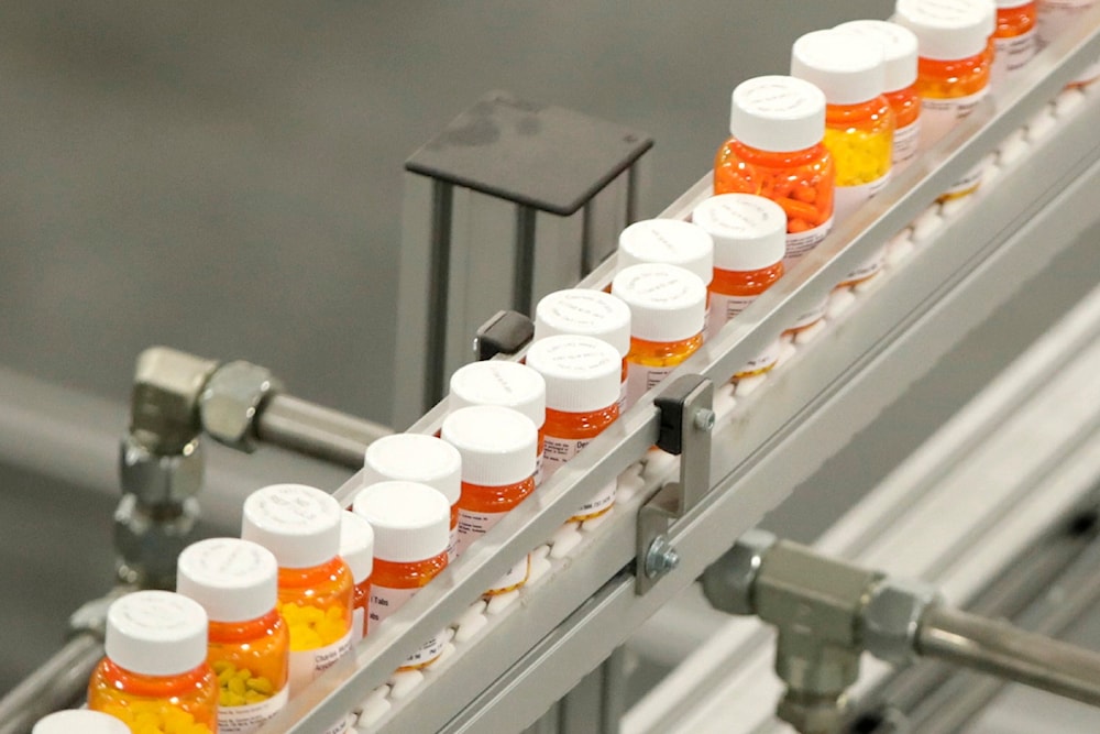 In this July 10, 2018 file photo, bottles of medications ride on a belt at a mail-in pharmacy warehouse in Florence, New Jersey (AP)