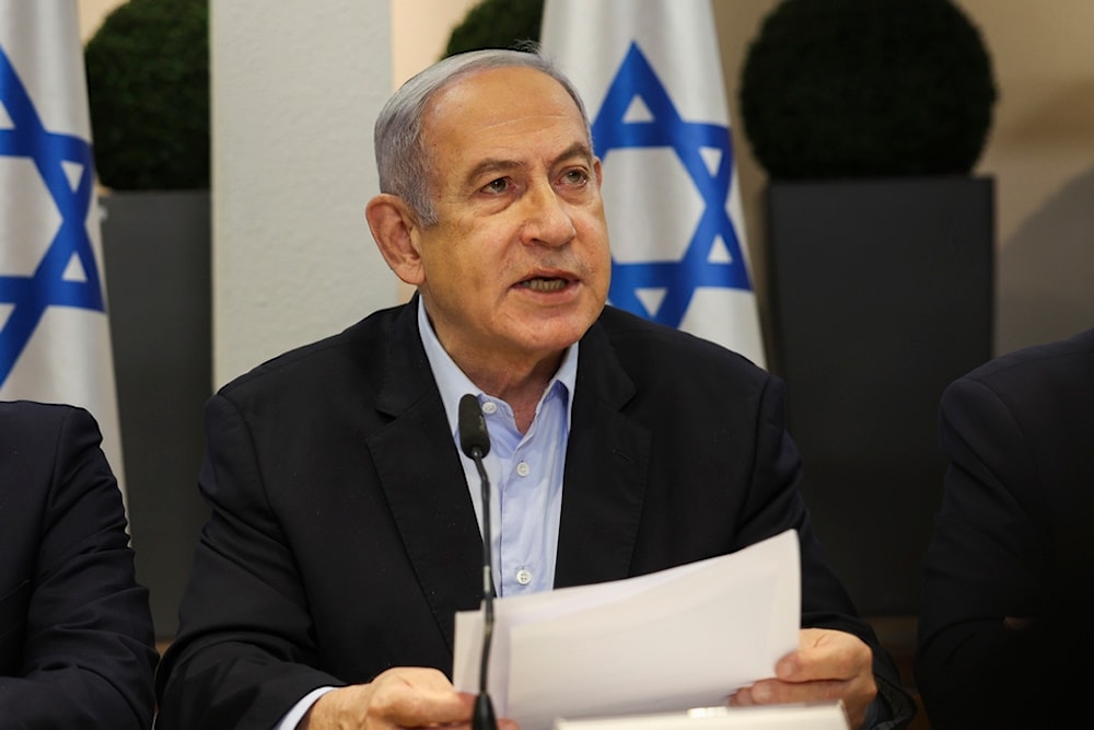 Israeli Prime Minister Benjamin Netanyahu, centre, speaks during the weekly cabinet meeting at the Defence Ministry in 