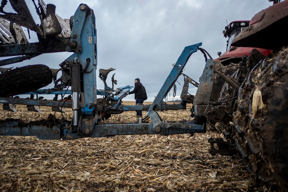 A farmer operates a tractor at a cornfield in Sumy region, Ukraine, on Friday, Nov. 24, 2023. (AP)