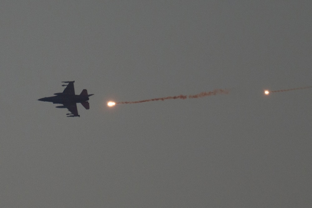 An Israeli fighter jet releases flares as it flies over the Gaza Strip, as seen from southern occupied Palestine, Tuesday, Jan. 16, 2024. (AP Photo/Leo Correa)