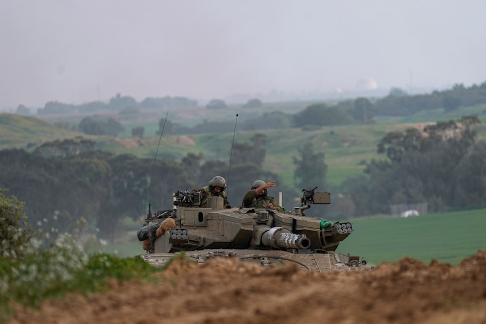 Israeli army tank moves near the Israeli-Gaza border, in southern occupied Palestine, Wednesday, Jan. 17, 2024.(AP Photo/Ohad Zwigenberg)