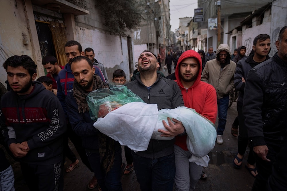 Mohammad Shouman carries the body of his daughter, Masa, who was killed in an Israeli bombardment of the Gaza Strip, during her funeral in Rafah, southern Gaza, Wednesday, Jan. 17, 2024 (AP Photo/Fatima Shbair)