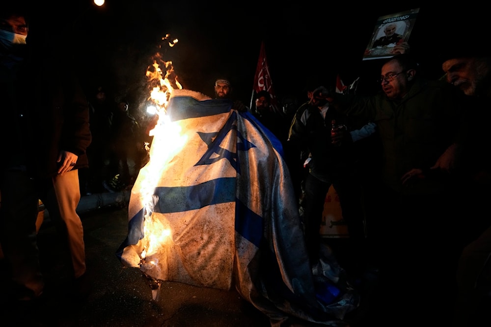 Iranian demonstrators burn an Israeli flag during a protest against the U.S. and British military strikes against Yemen, in front of the British Embassy in Tehran, Iran, Friday, Jan. 12, 2024. (AP)