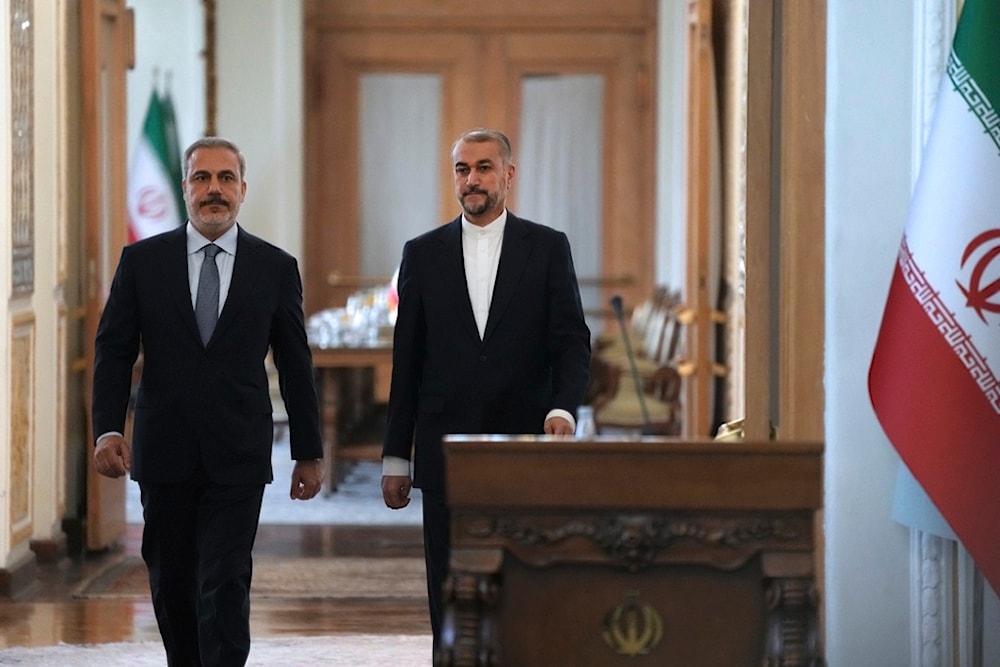 Iranian Foreign Minister Hossein Amirabdollahian, right, and his Turkish counterpart Hakan Fidan, arrive for their joint press briefing in Tehran, Iran, Sunday, Sept. 3, 2023. (AP)