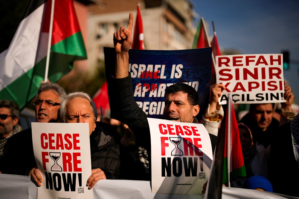 People shout slogans as they march in support of Palestinians during a protest calling for an immediate ceasefire in Gaza, in Istanbul, Turkey, Sunday, Jan. 14, 2024. (AP)