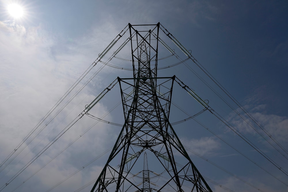 An electricity pylon is seen in Lydd, southern England, Monday, Aug. 15, 2022. (AP)