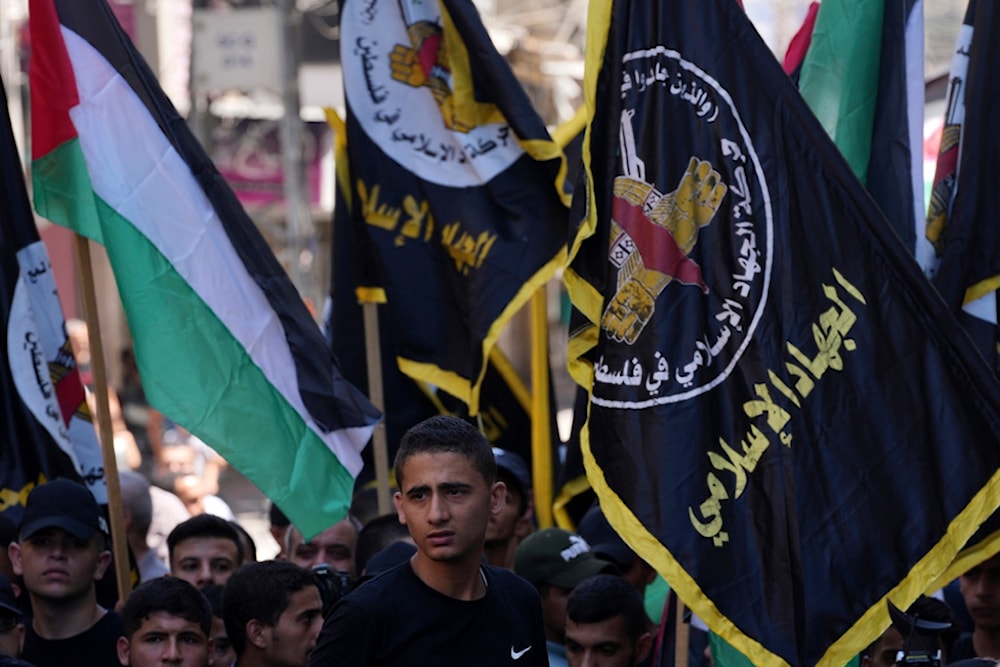 Palestinian Islamic Jihad supporters wave their movement and national flags during a protest in support of the Resistance in Gaza City, Friday, Aug. 4, 2023. Arabic on flags reads: 'Islamic Jihad'. (AP)