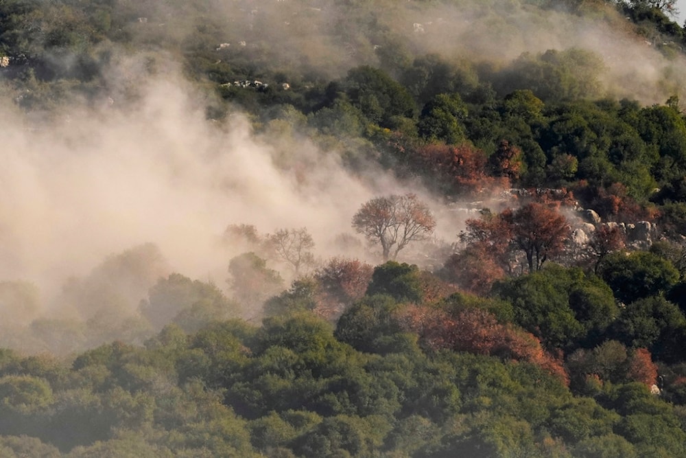 Smoke rises from Israeli artillery shelling on the outskirts of Yaroun, a Lebanese border village, in south Lebanon, Sunday, Dec. 10, 2023 (AP Photo/Hassan Ammar)