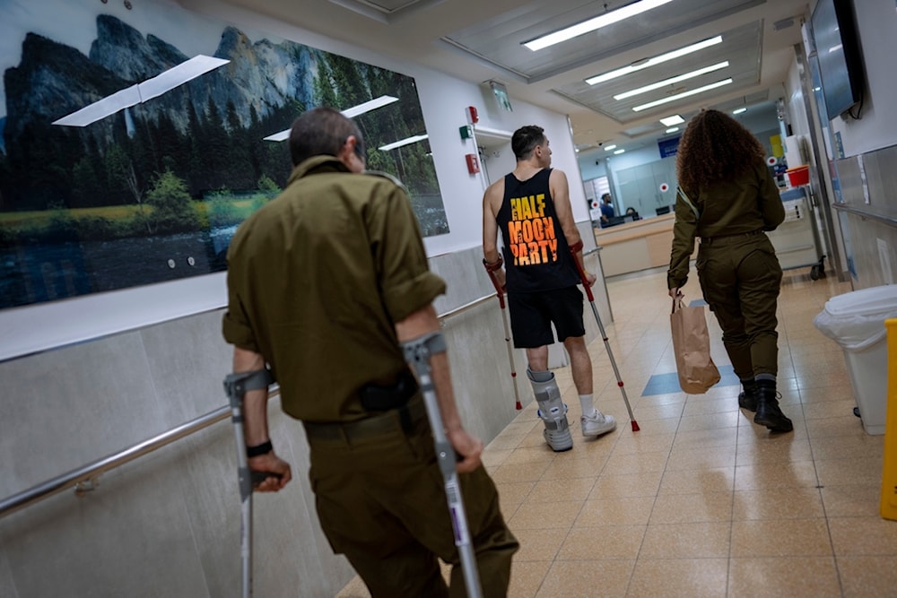 Israeli occupation soldiers wounded in the Israeli incursion into the Gaza Strip walk in the rehabilitation division of 'Sheba' hospital, 'Israel', Monday, Dec. 18, 2023. (AP)