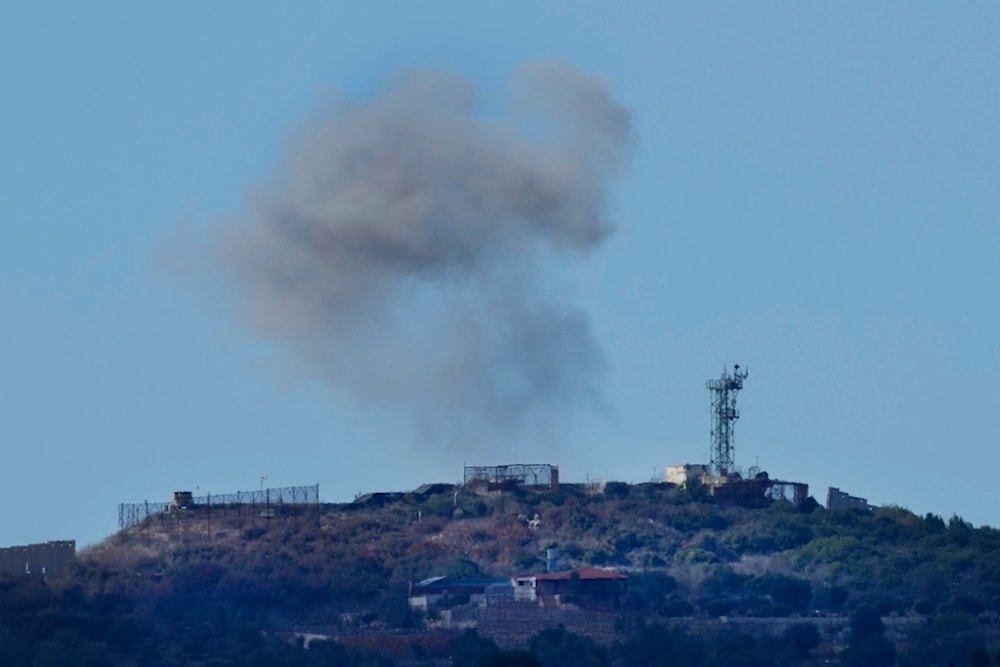 Smoke rises from an Israeli forces position which was hit by Hezbollah shells as it is seen from Rmeish, a Lebanese border village, in south Lebanon, Tuesday, Nov. 21, 2023 (AP Photo/Hussein Malla)
