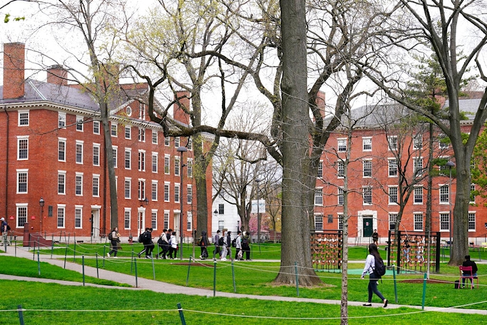 Students walk through Harvard Yard, April 27, 2022, on the campus of Harvard University in Cambridge, Mass (AP)