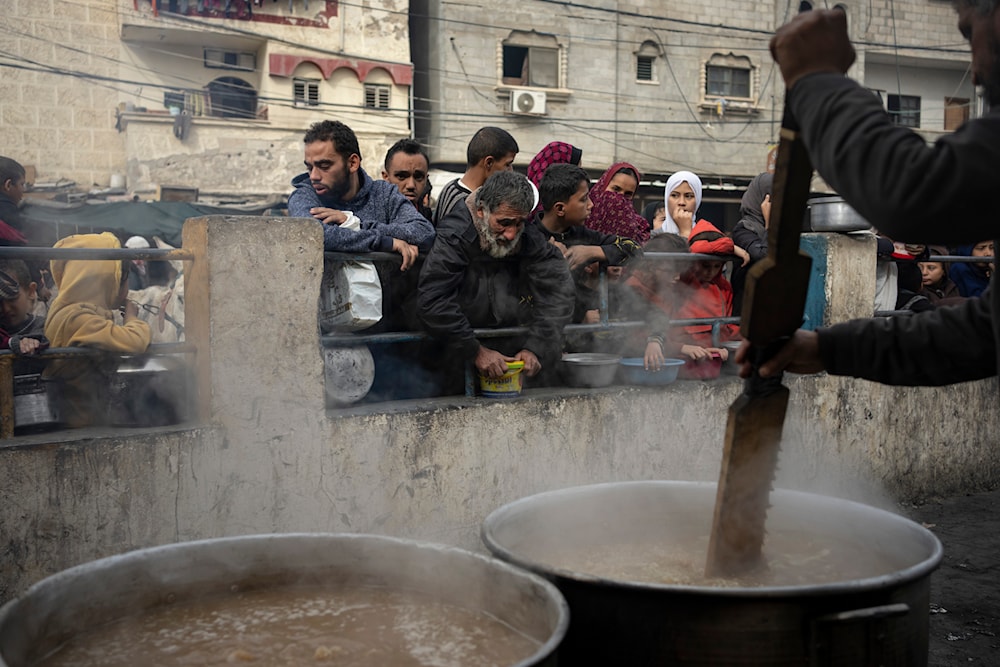 Palestinians line up for a free meal in Rafah, Gaza Strip, Thursday, Dec. 21, 2023.(AP)