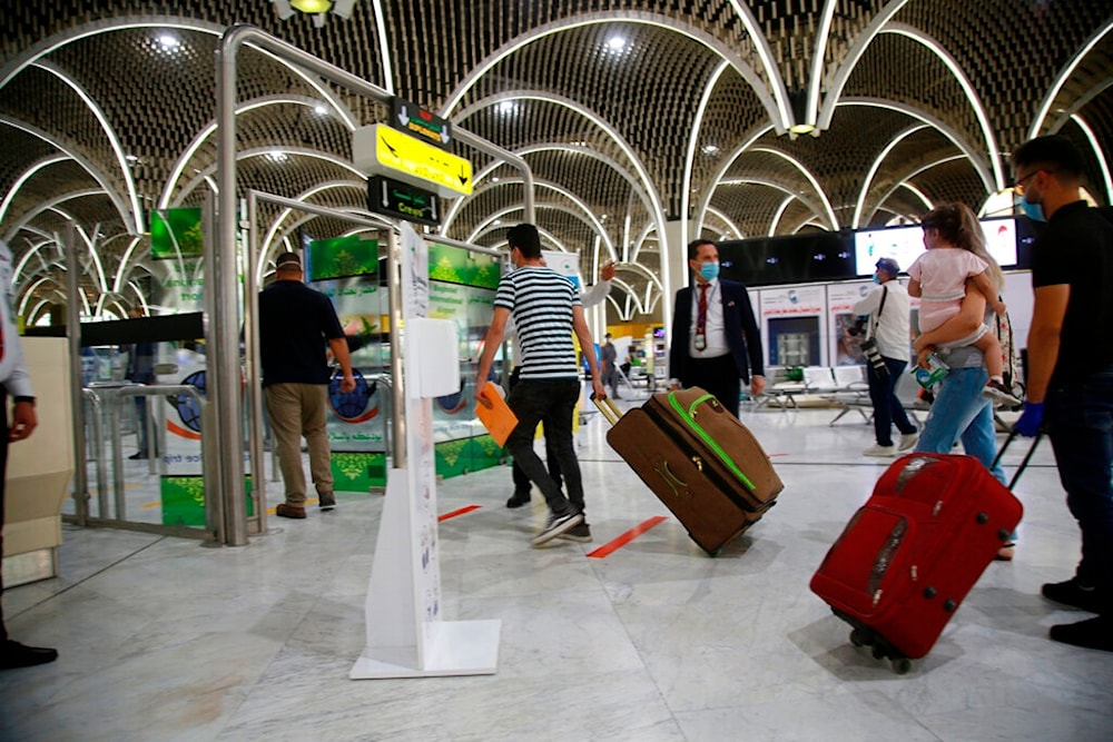 Passengers prepare to travel at the Baghdad Airport, in Baghdad, Iraq, Thursday, July, 23, 2020. (AP)