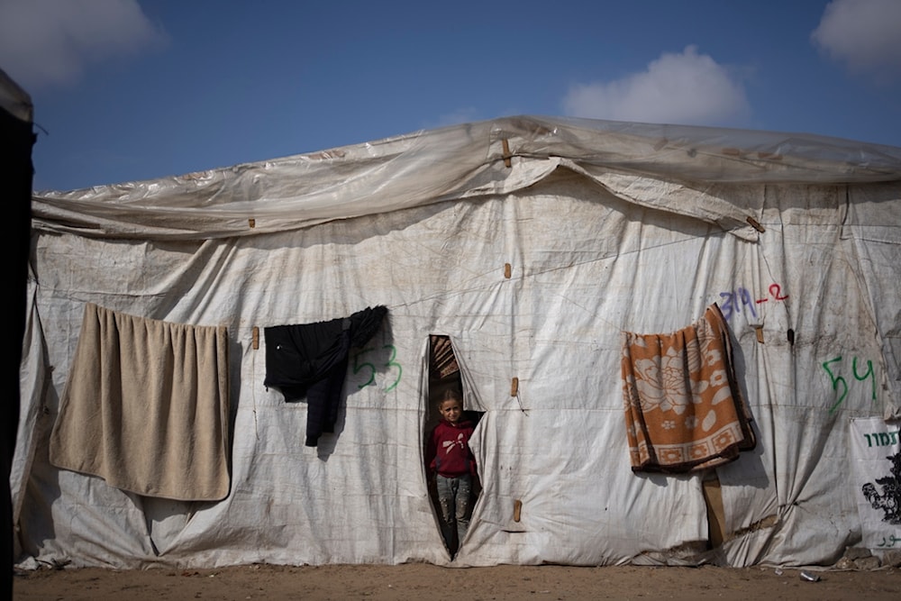 A Palestinian girl, displaced by the Israeli ground invasion against the Gaza Strip is seen at the makeshift tent camp in Rafah on Tuesday, Jan. 23, 2024 (AP)