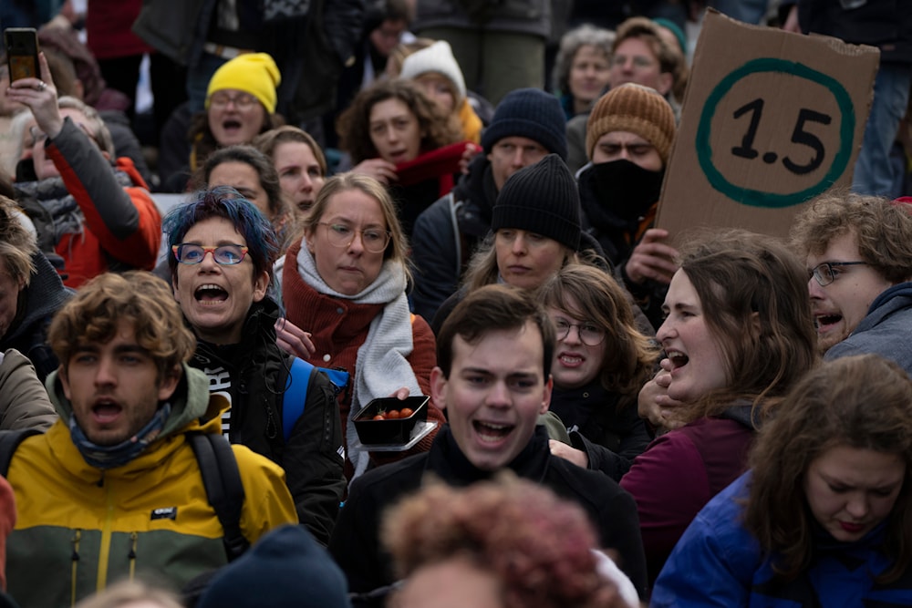 Activists, some from Extinction Rebellion shout slogans against global warming when blocking a busy road in The Hague, Netherlands, Jan. 28, 2023.(AP)