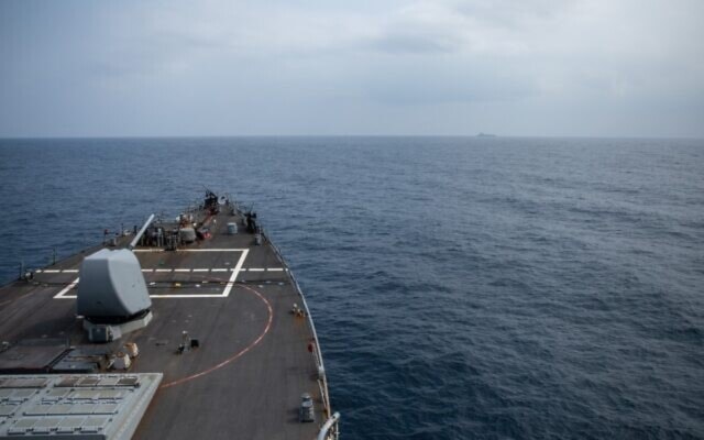 The Arleigh Burke-class guided-missile destroyer USS Laboon approaches the oiler USNS Kanawha (background) for replenishment-at-sea operation in the Red Sea on December 25, 2023, in this handout photo. (US Department of Defense / AFP)