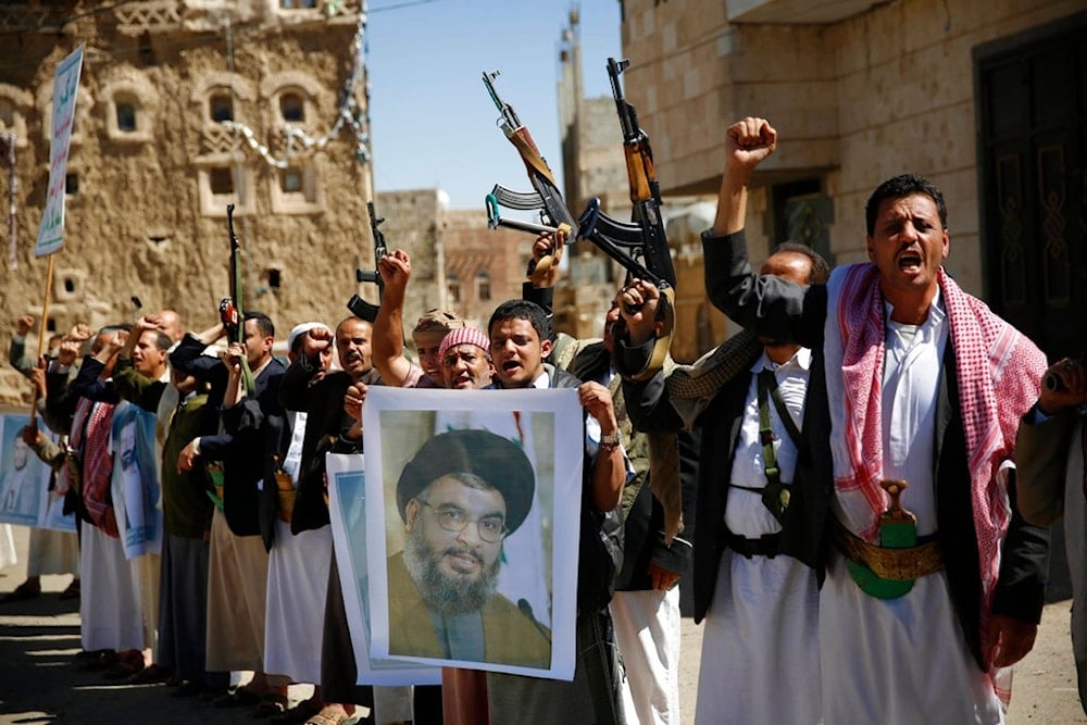 Yemenis rally in support of the Lebanese resistance holding a poster of Hezbollah Secretary General, March 3, 2016 (AP)