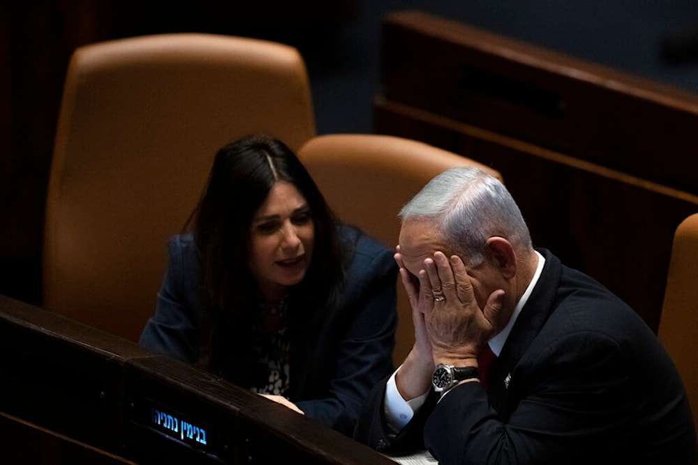 Israel's Prime Minister Benjamin Netanyahu, right, confers with Minister of Transport and Road Safety Miri Regev, left, February 20, 2023 (AP)