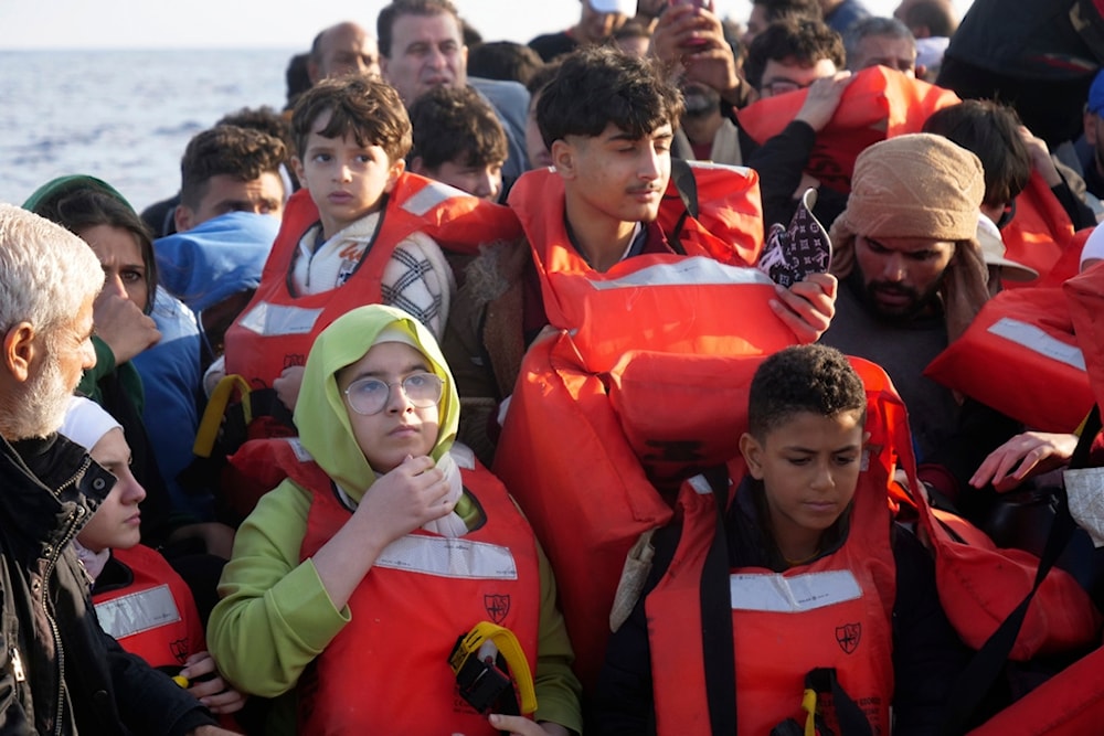 Migrants wear life vests as they are rescued by a MSF (Medecins Sans Frontiers) rescue team boat, after leaving Libya trying to reach European soil, in the Mediterranean Sea, Friday, Oct. 6, 2023. (AP)