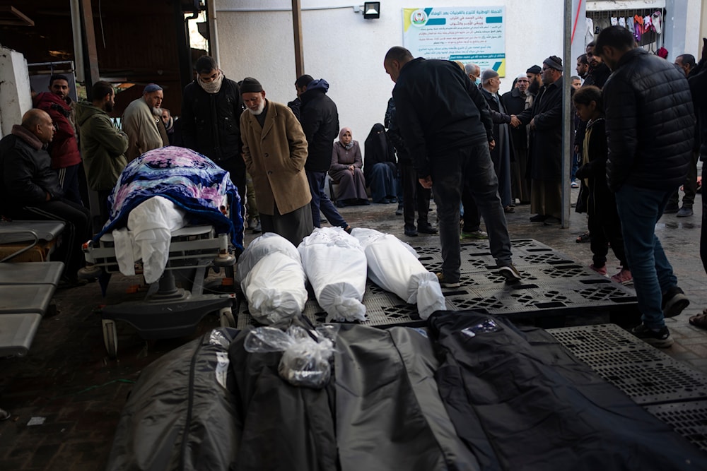 Palestinians gather around the bodies of martyrs who were killed by the Israeli ground  bombardment of Khan Younis, outside a morgue in Rafah, southern Gaza, Wednesday, Jan. 24, 2024(AP)