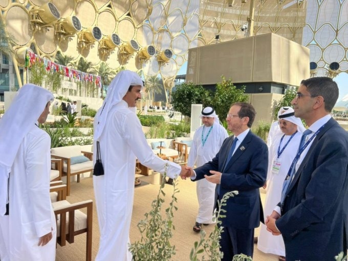 Qatar Emir Tamim bin Hamad al-Thani shakes hands with Israeli occupation President Isaac Herzog, UAE, Abu Dhabi, December 1 2023 (social media)