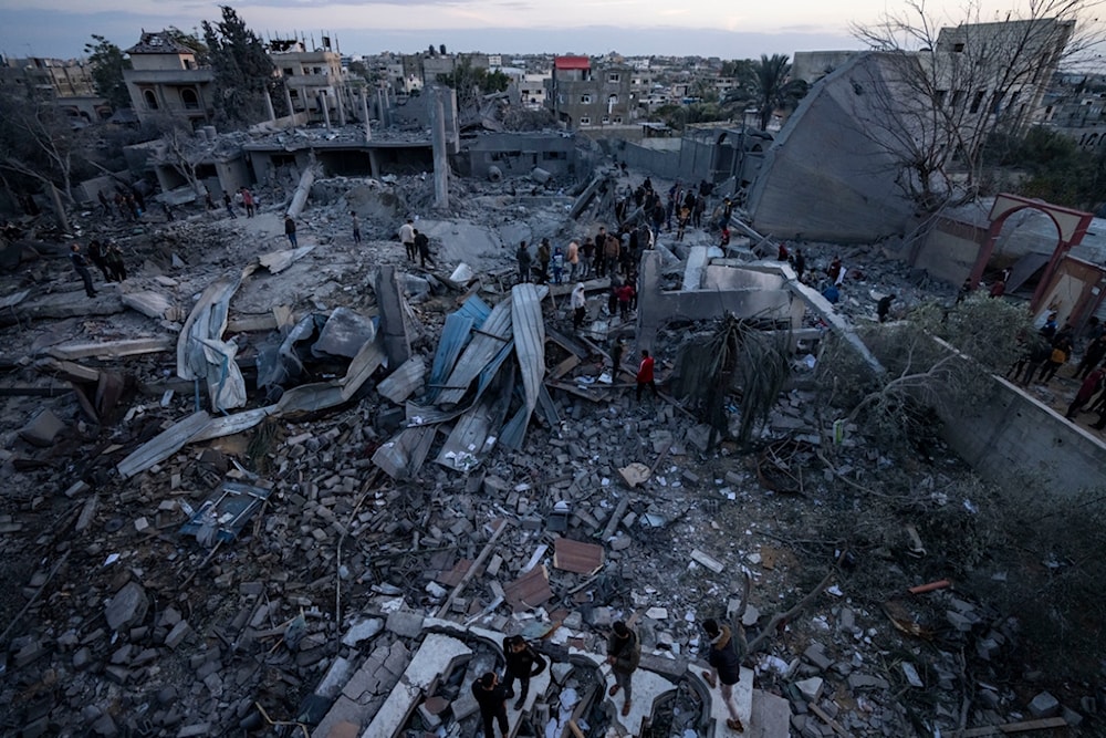 Palestinians look at a mosque destroyed in an Israeli strike in Rafah, Gaza Strip Wednesday, Jan. 24, 2024. (AP Photo/Fatima Shbair)