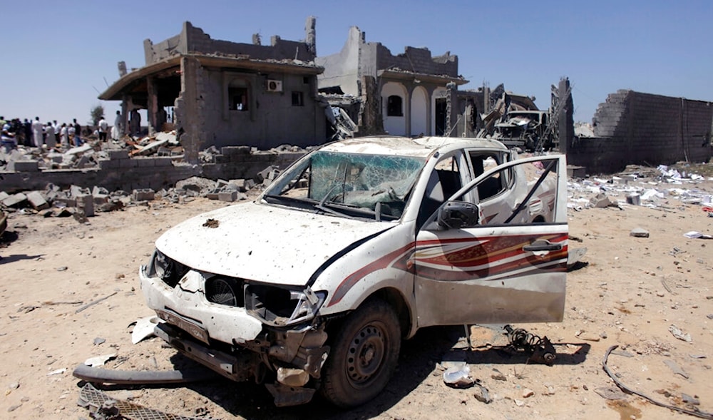 In this file photo taken on a government-organized tour, a destroyed car stands in front of a bombed out home after it was raided by a NATO bomb in the town of Majar, Libya, on Aug. 9, 2011. (AP)