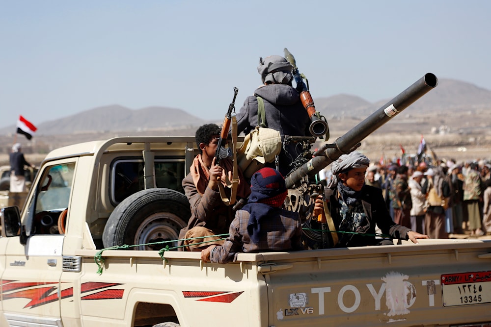 Houthi fighters and tribesmen stage a rally against the US and the UK strikes on Yemeni military sites near Sanaa, Yemen, on Sunday, Jan. 14, 2024. (AP)