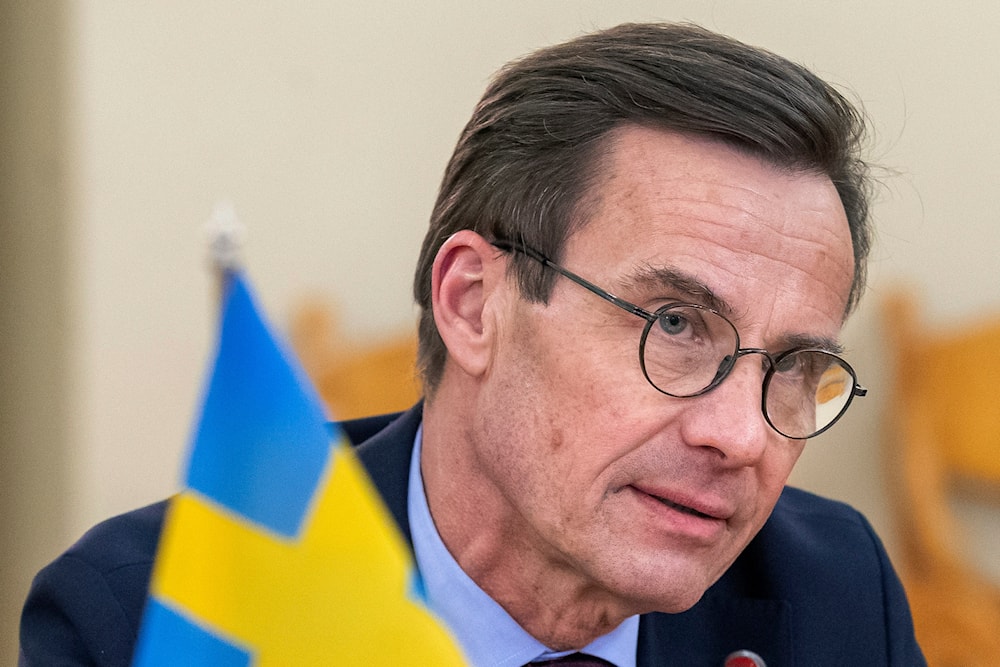 Sweden's Prime Minister Ulf Kristersson listens during the meeting with Lithuanian President Gitanas Nauseda at the President's palace in Vilnius, Lithuania, Tuesday, Feb. 7, 2023. (AP)