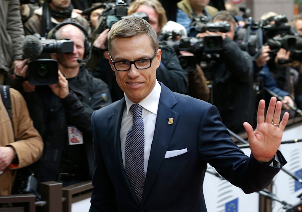 Finland's Prime Minister Alexander Stubb waves to the media upon arrival on the second day of an EU summit in Brussels, on Friday, Oct. 24, 2014. (AP)